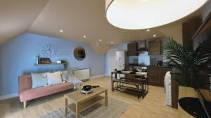 a living room with a couch and a table at Group Bookings: Up To 30 Guests Across 5 Spacious Flats! Keyless Access Free Wifi & Parking in Birmingham