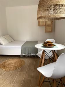 a room with a bed and a table and chairs at Pokoje blisko morza in Sarbinowo