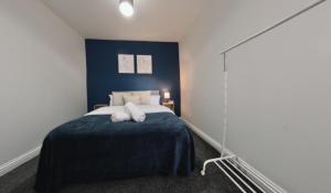a bedroom with a bed with two pillows on it at Group Bookings: Up To 30 Guests Across 5 Spacious Flats! Keyless Access Free Wifi & Parking in Birmingham