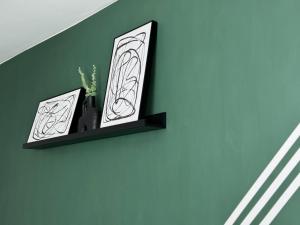 a shelf with two vases and a plant on a wall at Group Bookings: Up To 30 Guests Across 5 Spacious Flats! Keyless Access Free Wifi & Parking in Birmingham