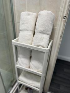 a group of towels on a rack in a bathroom at Group Bookings: Up To 30 Guests Across 5 Spacious Flats! Keyless Access Free Wifi & Parking in Birmingham
