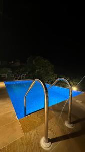 a swimming pool at night with a blue pool at Casa Campestre Luxuri Bali in Darién