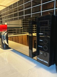 a microwave oven sitting on top of a kitchen counter at HOPE-always in Cape Town