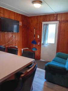 a conference room with a table and chairs and a door at cabin 1 in Manistique