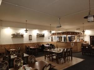 a dining room with tables and chairs in a restaurant at Hotel Kamenný vrch in Chomutov