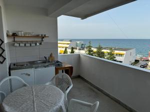 a balcony with a table and chairs and the ocean at obzor, orkinos in Obzor