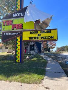 a sign for a pet store with a book online at TeePee Room 17- Full Kitchen in Roscommon