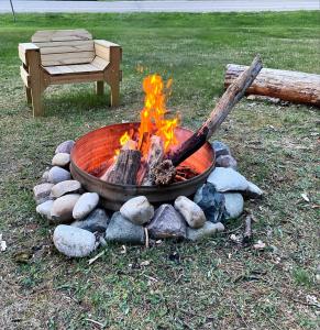 a fire pit in the grass next to a bench at TeePee Room 17- Full Kitchen in Roscommon