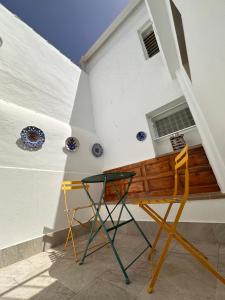 a chair and a desk in front of a building at La Casa AZUL in Ardales