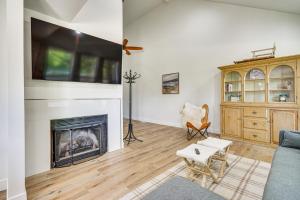 a living room with a fireplace and a tv at Cottonwood Heights Escape Near Hiking and Skiing in Cottonwood Heights