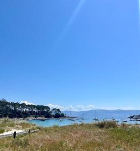 a view of a beach with boats in the water at Ondas do Mar Boutique Stays - Portonovo 2 in Portonovo