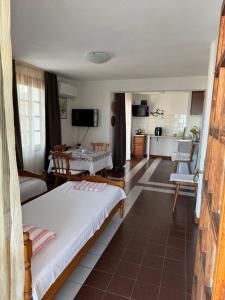 a bedroom with a bed and a living room at obzor, orkinos in Obzor +16 photos