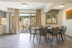 a dining room with a table and chairs at AM Suites Kefalonia in Argostoli