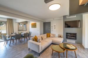 a living room with a couch and a table at AM Suites Kefalonia in Argostoli