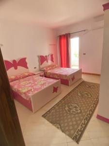 a bedroom with two beds and a window at Palemera in Ain Sokhna