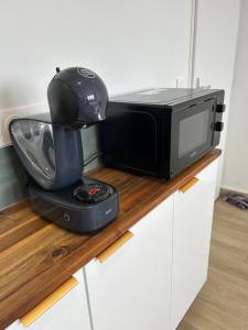 a coffee maker sitting on top of a microwave at Studio Siana in Chartres +8 photos