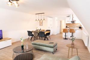 a living room and dining room with a table and chairs at Apartments am Marktplatz in Bad Urach
