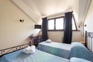 Postel nebo postele na pokoji v ubytování Villa Collina dei Pini