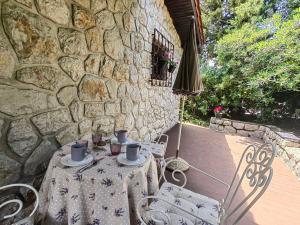 a table with two chairs and a stone wall at Apartment Lada in Dramalj