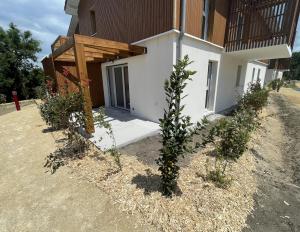 a building with a tree in front of it at T2 neuf proche ocean in Messanges