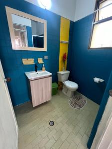 a blue bathroom with a sink and a toilet at APTO FAMILIAR La POLA 2 ALCOBAS in Ibagué