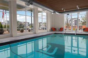 a swimming pool with views of a building at Aloft by Marriott Broomfield Denver in Broomfield