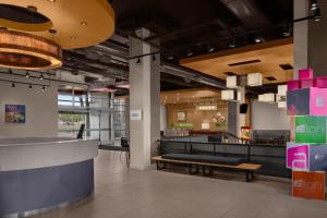 a lobby of a restaurant with a bench at Aloft by Marriott Broomfield Denver in Broomfield