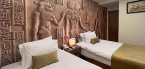Postel nebo postele na pokoji v ubytování Moon Pyramids Inn