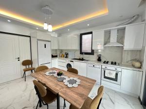 a kitchen with a wooden table and chairs in it at Dalyan villa star 1 in Ortaca