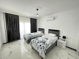 a bedroom with two beds and a large window at Dalyan villa star 1 in Ortaca +15 photos