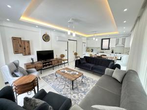 a living room with a couch and a table at Dalyan villa star 1 in Ortaca