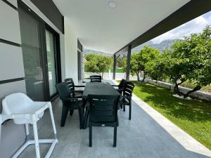 a dining room with a table and chairs on a patio at Dalyan villa star 1 in Ortaca