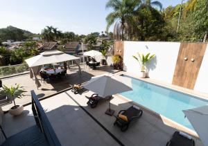 an overhead view of a swimming pool with umbrellas and chairs at Hotel Terras da Finlândia in Penedo