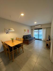 a living room with a table and a couch at Montevideo Suite in Rosario