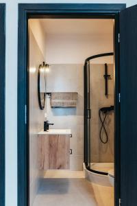 a bathroom with a shower and a sink at Hostel Kamienica 9 in Sosnowiec