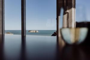 a view of the ocean from a room with a window at Ocean View Bach in Motunau