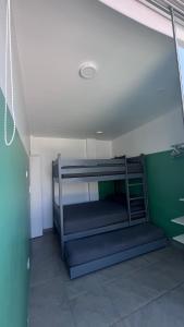 a room with two bunk beds in a room at Casa Tres Ventanas de Azpitia in Santa Cruz de Flores