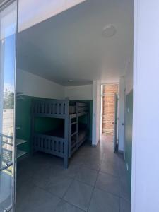 a room with a room with green walls and a glass door at Casa Tres Ventanas de Azpitia in Santa Cruz de Flores