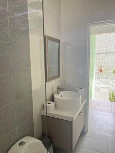 a bathroom with a sink and a toilet at Casa Tres Ventanas de Azpitia in Santa Cruz de Flores