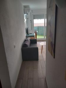 a view of a living room with a couch at Apartamento cerca del Mar in Empuriabrava +2 photos