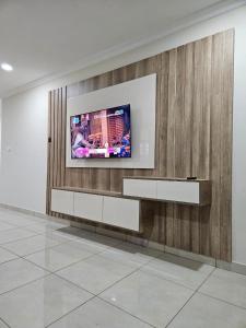 a flat screen tv on a wall in a building at Summit Residence in Accra +14 photos