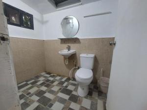 a bathroom with a toilet and a sink at Larmar bed and breakfast in Puerto Princesa City +62 photos