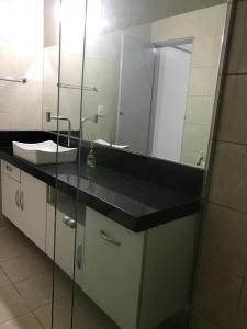 a bathroom with a sink and a mirror at Linhares hospedagem in João Pessoa