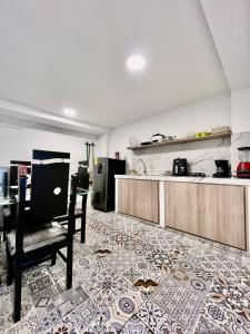 une cuisine avec un comptoir, une table et une chaise dans l'établissement aparta estudio de lujo, à Pasto