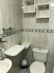 a bathroom with a white toilet and a sink at Linhares hospedagem in João Pessoa +33 photos