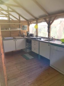 a kitchen with white cabinets and a counter top at Evasion in Ventiseri