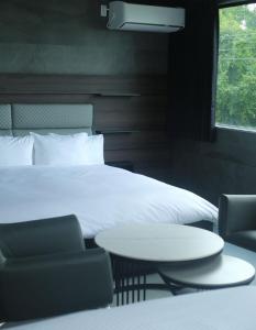 A bed or beds in a room at プラフィーノリゾートヴィラ