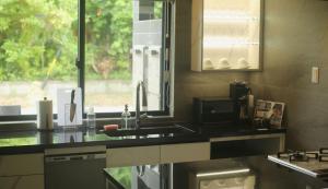 A kitchen or kitchenette at プラフィーノリゾートヴィラ