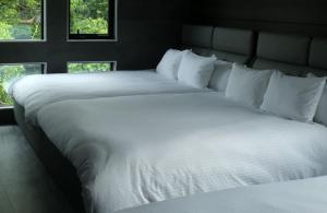 A bed or beds in a room at プラフィーノリゾートヴィラ