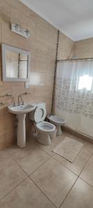 a bathroom with a sink and a toilet and a shower at Lo de Marga - hasta 7 personas- in Federación